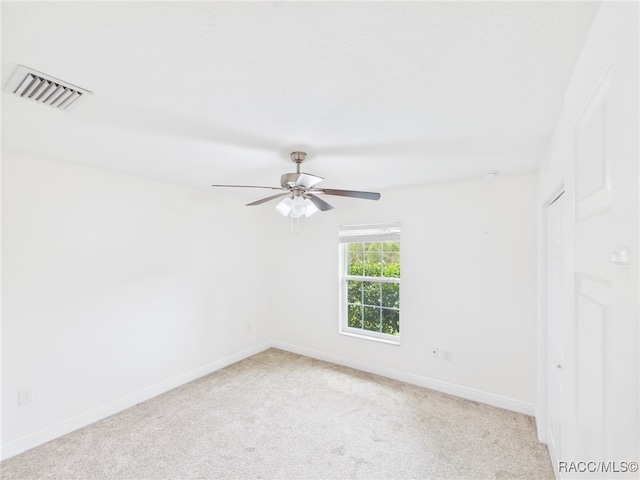 1899 W Oliver Dr, Citrus Springs, FL 34434 - spare room featuring light carpet and a ceiling fan