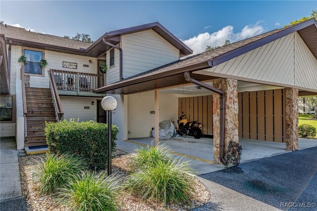 340 E Glassboro Ct Unit 19-5A, Hernando, FL 34442 - view of front of house with stairway, a carport, roof with shingles, and driveway