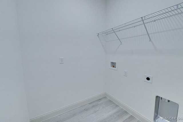 laundry room featuring hookup for an electric dryer, washer hookup, and light hardwood / wood-style floors