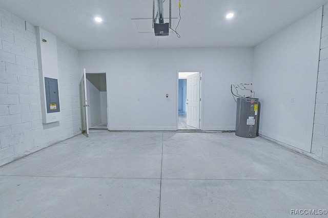 garage featuring electric panel, water heater, and a garage door opener