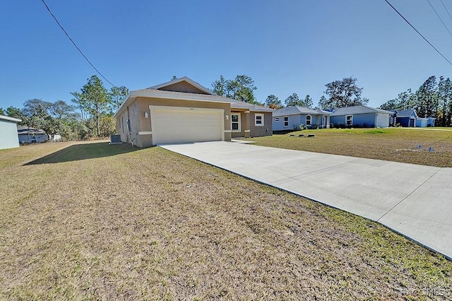 ranch-style home with a garage and a front lawn