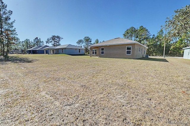 rear view of property featuring a lawn