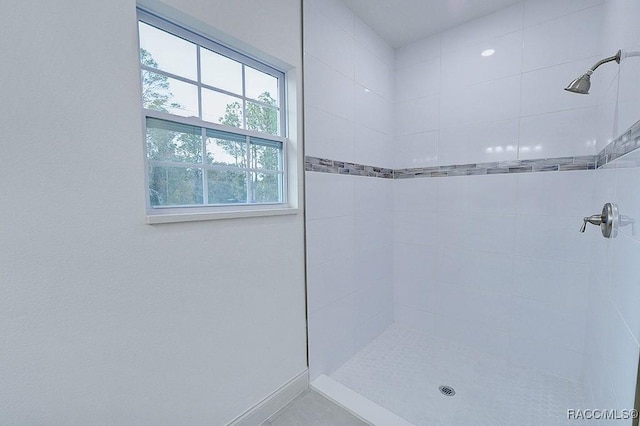 bathroom with tiled shower