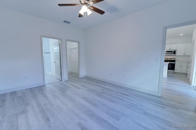 unfurnished room featuring ceiling fan and light hardwood / wood-style floors