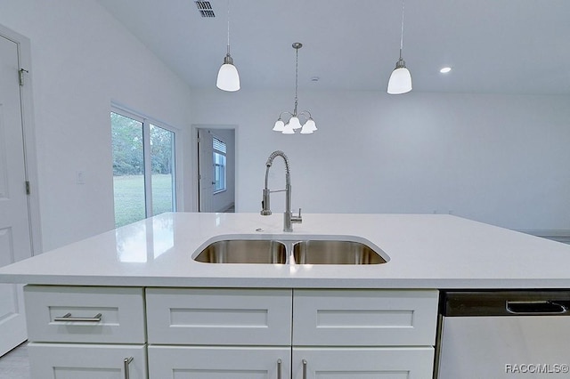 kitchen with white cabinets, an island with sink, stainless steel dishwasher, and sink