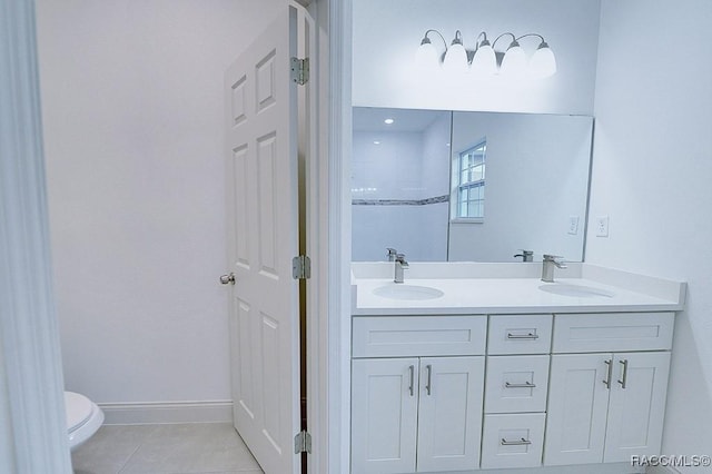 bathroom with tile patterned flooring, vanity, and toilet