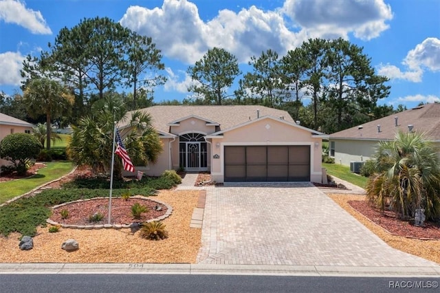15776 SW 11th Terrace Rd, Ocala, FL 34473 - ranch-style house featuring stucco siding, an attached garage, and decorative driveway