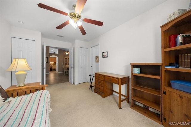 15776 SW 11th Terrace Rd, Ocala, FL 34473 - bedroom with light carpet, ceiling fan, and arched walkways