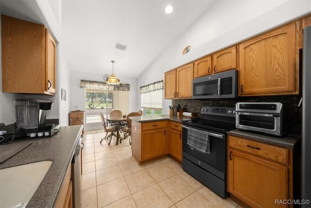 15776 SW 11th Terrace Rd, Ocala, FL 34473 - kitchen featuring stainless steel appliances, vaulted ceiling, dark countertops, a peninsula, and light tile patterned flooring