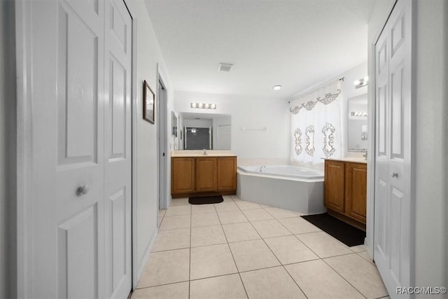 15776 SW 11th Terrace Rd, Ocala, FL 34473 - full bath featuring two vanities, a closet, a bath, and tile patterned flooring