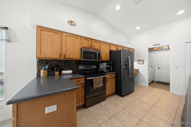 15776 SW 11th Terrace Rd, Ocala, FL 34473 - kitchen with stainless steel appliances, dark countertops, tasteful backsplash, vaulted ceiling, and light tile patterned flooring