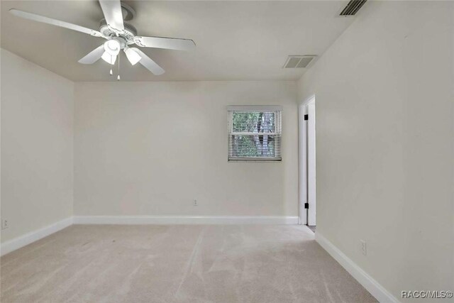 657 NE 11th St, Crystal River, FL 34428 - unfurnished room featuring light carpet, baseboards, and a ceiling fan