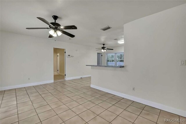 657 NE 11th St, Crystal River, FL 34428 - unfurnished room featuring ceiling fan, baseboards, and light tile patterned floors