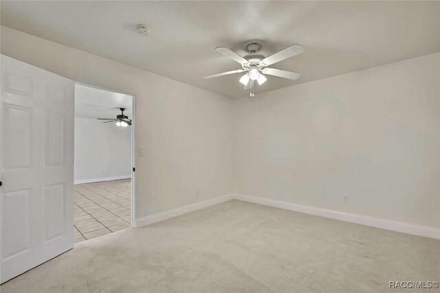 657 NE 11th St, Crystal River, FL 34428 - spare room featuring light carpet, a ceiling fan, and baseboards