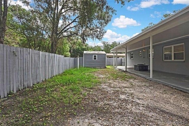 657 NE 11th St, Crystal River, FL 34428 - fenced backyard with a patio area and central AC unit
