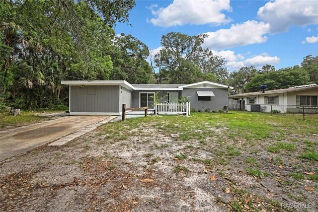 657 NE 11th St, Crystal River, FL 34428 - view of front of house featuring view of wooded area and driveway