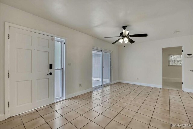 657 NE 11th St, Crystal River, FL 34428 - spare room featuring ceiling fan, baseboards, light tile patterned flooring, and a smoke detector