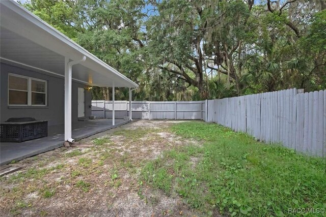 657 NE 11th St, Crystal River, FL 34428 - fenced backyard with a patio area