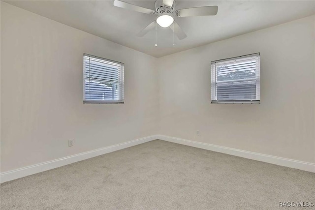 657 NE 11th St, Crystal River, FL 34428 - spare room featuring baseboards, carpet, and a ceiling fan
