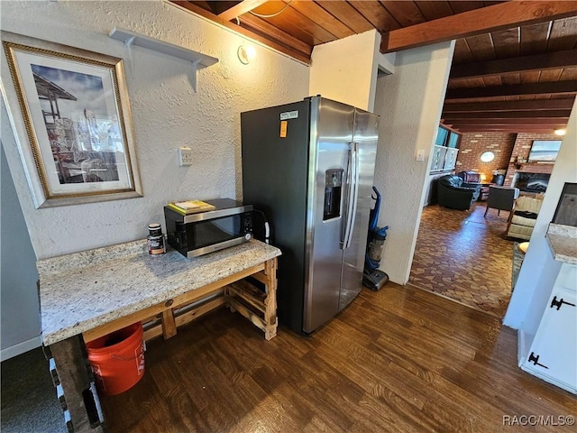 kitchen featuring light stone counters, dark wood-type flooring, wood ceiling, and appliances with stainless steel finishes