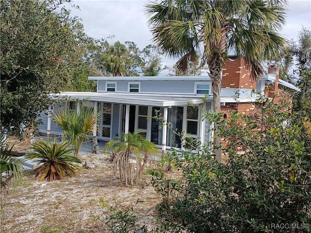 back of house with a sunroom