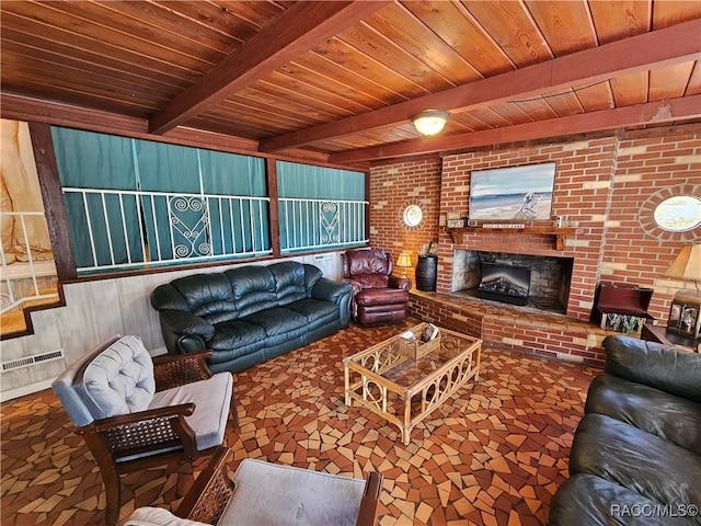 living room with beamed ceiling, wood ceiling, and brick wall