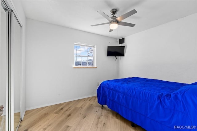 bedroom with ceiling fan and light hardwood / wood-style flooring