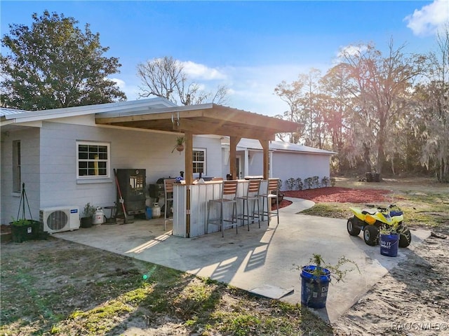 view of patio featuring ac unit and an outdoor bar