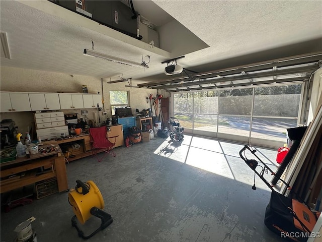 garage featuring a garage door opener and a workshop area