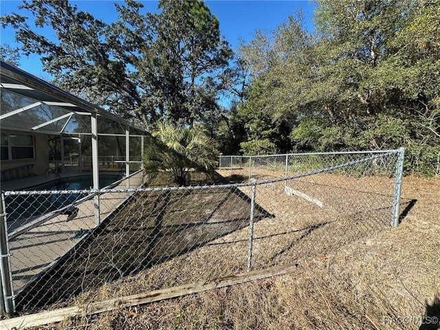 view of yard featuring glass enclosure and a fenced in pool