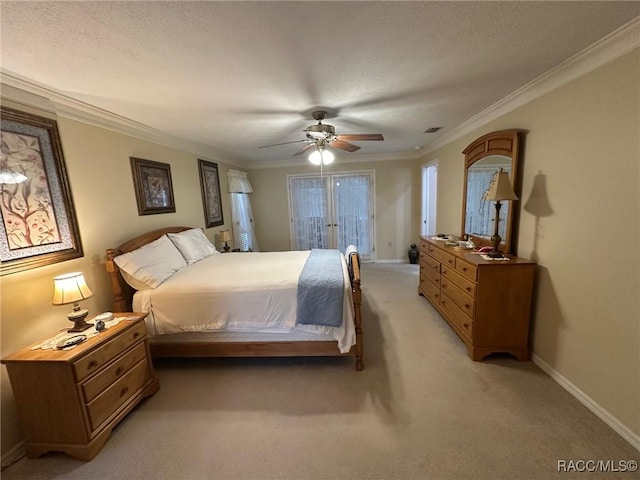 bedroom featuring light carpet, a textured ceiling, ceiling fan, and ornamental molding