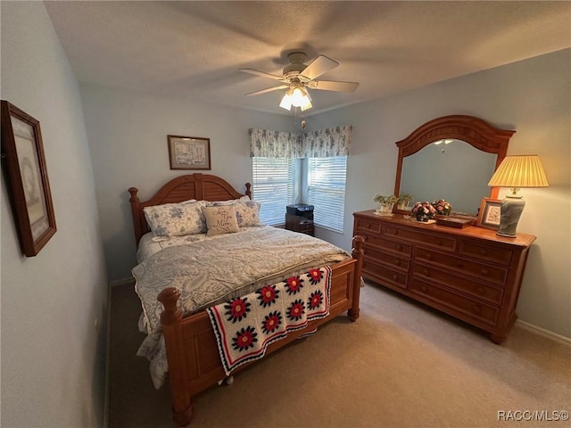 bedroom with ceiling fan and light carpet