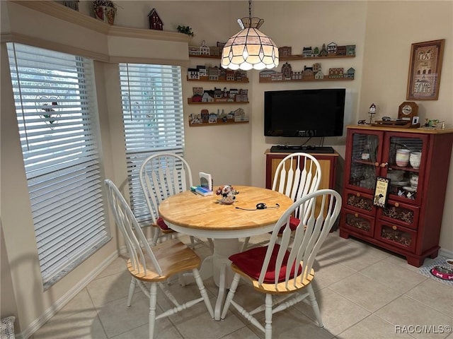 dining space featuring light tile patterned flooring