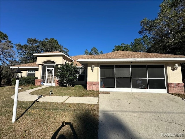 view of front facade featuring a front yard and a garage