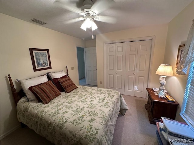 carpeted bedroom featuring a closet and ceiling fan