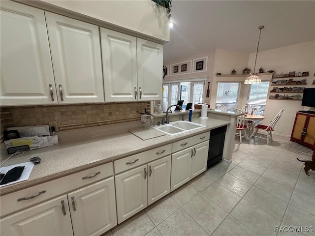 kitchen with white cabinetry, hanging light fixtures, sink, tasteful backsplash, and dishwasher