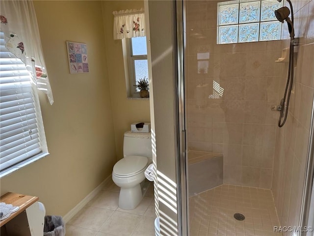 bathroom featuring tile patterned flooring, toilet, and walk in shower