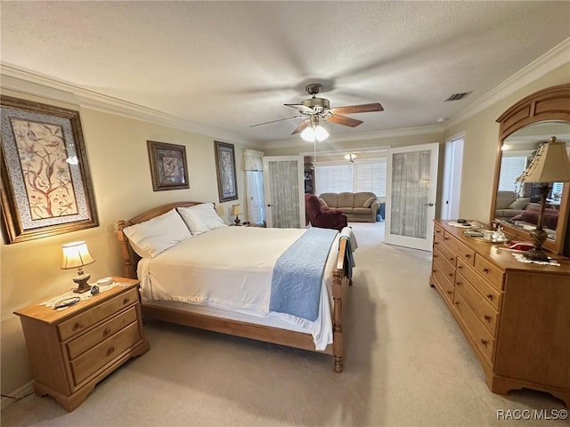 carpeted bedroom featuring a textured ceiling, ornamental molding, and ceiling fan