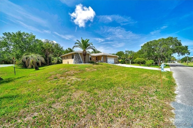 10741 W Pine Bark Ln, Crystal River, FL 34429 - view of front of home with a garage, driveway, and a front lawn