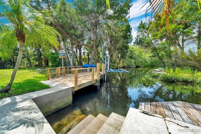 10741 W Pine Bark Ln, Crystal River, FL 34429 - dock area with a water view, a lawn, and view of wooded area