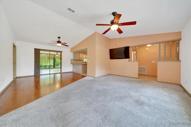 10741 W Pine Bark Ln, Crystal River, FL 34429 - unfurnished living room featuring a ceiling fan, lofted ceiling, and carpet