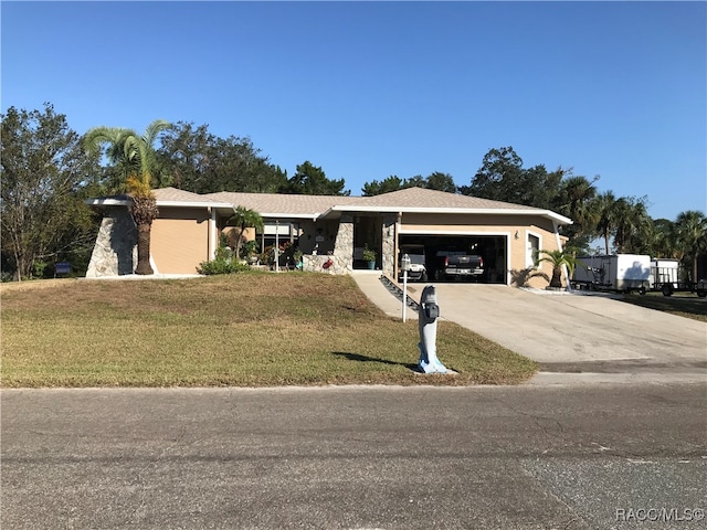 ranch-style house with a garage and a front lawn