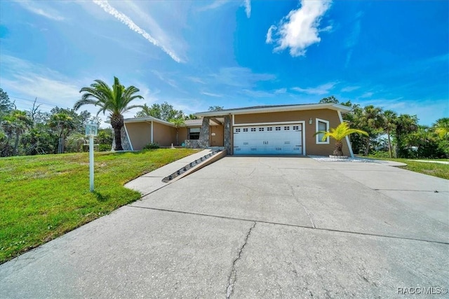 10741 W Pine Bark Ln, Crystal River, FL 34429 - view of front facade with an attached garage, concrete driveway, a front lawn, and stucco siding
