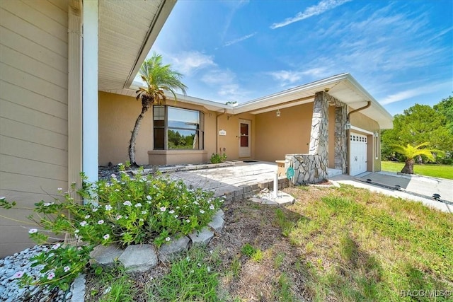 10741 W Pine Bark Ln, Crystal River, FL 34429 - view of front facade featuring a garage and stucco siding