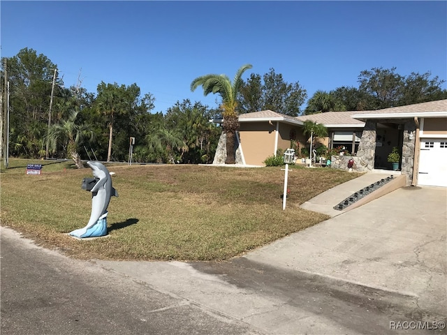 view of front of house with a garage and a front yard