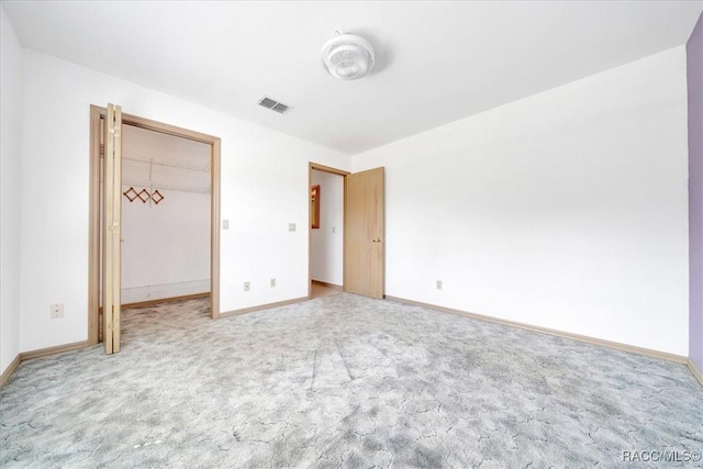10741 W Pine Bark Ln, Crystal River, FL 34429 - unfurnished bedroom featuring light carpet and a walk in closet