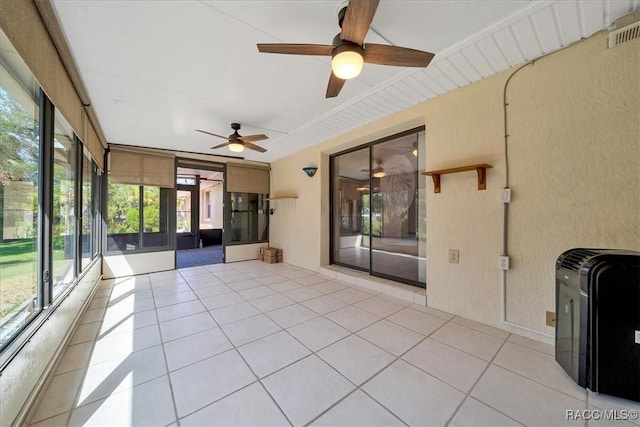 10741 W Pine Bark Ln, Crystal River, FL 34429 - unfurnished sunroom featuring ceiling fan, a textured wall, and tile patterned floors