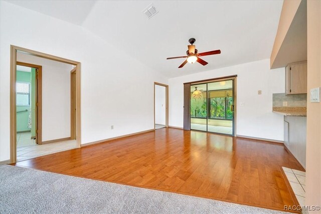 10741 W Pine Bark Ln, Crystal River, FL 34429 - unfurnished living room featuring plenty of natural light, a ceiling fan, and light wood-style floors
