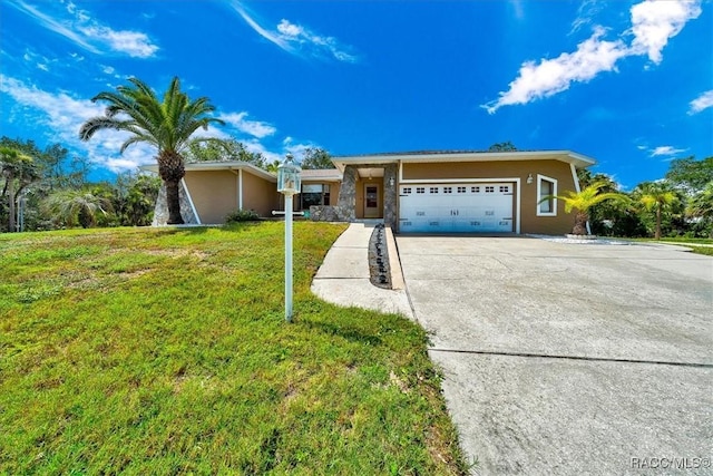 10741 W Pine Bark Ln, Crystal River, FL 34429 - view of front facade featuring concrete driveway, a garage, and a front yard