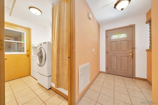 10741 W Pine Bark Ln, Crystal River, FL 34429 - laundry area with light tile patterned floors and washer / dryer